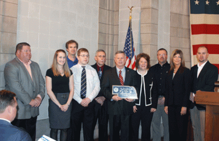 Falls City was honored at the State Capitol April 2 as the 2013 winner of the Governor’s Showcase Community Award. On hand for the presentation from Gov. Dave Heineman, from left: Bart Keller, Carla Rhodd, Ryan Schutte, Eric Barr, Jerry Oliver, Gov. Heineman, Beckie Cromer, Gary Jorn, Beth Sickel and Eric Kresin of CGB.