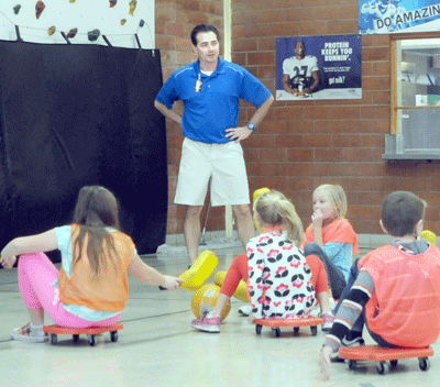 North and South Elementary Physical Education teacher Joe Dunn referees while students from Mrs. Stacey Duerfeldt’s third-grade class play a game of “Scooter Cage Ball.” Dunn was honored as the Elementary Physical Education Teacher of the Year by the Nebraska Association for Health, Physical Education, Recreation and Dance at a ceremony in Lincoln earlier this month. Photo by Jim Langan.