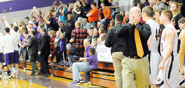 Nemaha Valley and Falls City High fans, players and coaches, notably FCHS Head Coach Don Hogue (front right), display both sides of the emotional spectrum Saturday following Justice McKernan’s game-winning buzzer-beater in overtime. McKernan’s shot was the difference-maker in a 68-66 thriller between the Raiders and the Tigers during the Raider Classic championship game in Seneca, KS. Photo by Jim Langan.   