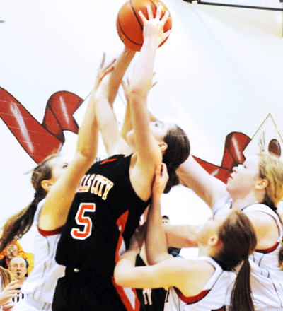 A determined Madison Olberding ignores the contact of at least three Lady Eagle defenders and pulls down an offensive rebound in the second half of the Lady Tigers 39-34 overtime loss at Johnson-Brock last Thursday. The Falls City High senior helped her team scratch-and-claw their way back into the ballgame after falling behind by six at halftime. Olberding finished with 10 rebounds, including six offensive boards – both team-highs – and scored eight points. Photo by Jim Langan.