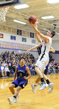 Tiger junior Jordy Stoller finishes a fastbreak layup Saturday night against Nemaha Valley during the championship game of the Raider Classic at Seneca, KS. The bucket by Stolller, who finished with a game-high 23 points and five steals, capped off an 8-0 FC run and trimmed a 13-point Nemaha Valley lead to five points midway through the fourth quarter. Photo by Jim Langan. 