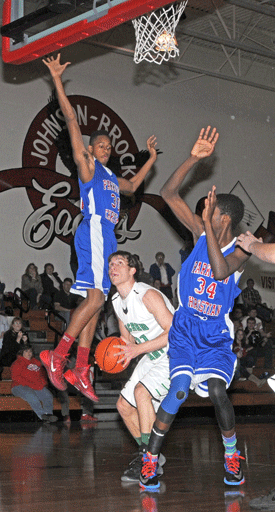FC Sacred Heart senior Matt Goltz executes a perfect pump fake last Thursday night against Lincoln Parkview Christian defenders Henry Tanksley (No. 30) and Nosa Iyagbaye (No. 34) during the Irish’s 71-61 victory. Goltz finished with his sixth double-double – 11 points, 11 rebounds – and became the 13th player in school history to eclipse 1,000 career points (1,009). Photo by Emma Schock.